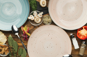 Set of empty ceramic plates on woden table