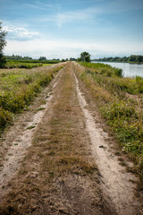 Fototapeta na wymiar Off road country path along a river side