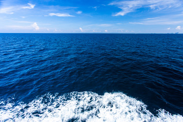 Blue Seawater with sea foam as background