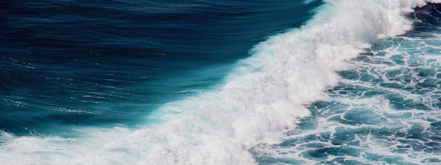 Indian ocean texture. Turquoise sea water with white foam. Powerful and peaceful nature concept.