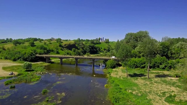 summer landscape drone flies over the river in sunny weather
