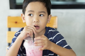 the boy suctioning a milk and ice