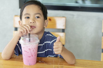 the boy suctioning a milk and ice