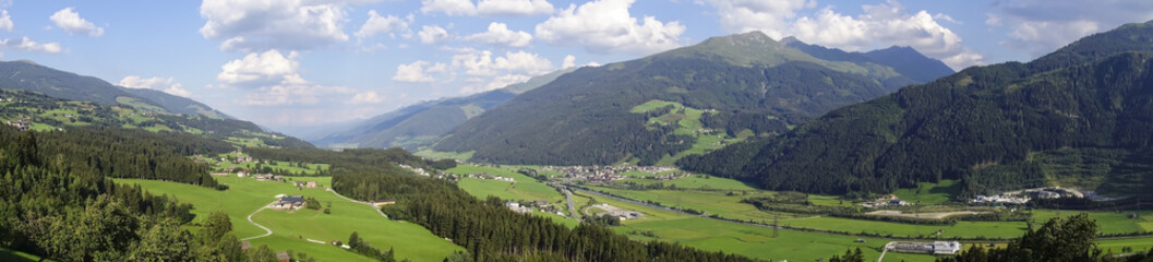 Fototapeta na wymiar Valley panorama with high mountains around