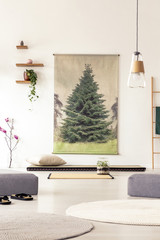 Real photo of a big japanese painting next to wooden shelves in a living room interior with asian mats and rugs