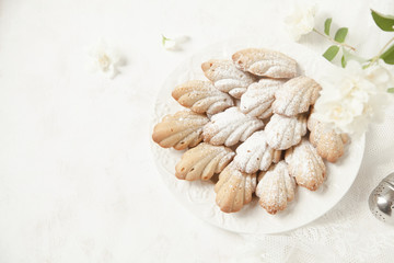 Homemade French cookies (cakes) Madeleine with jasmine tea on white background with fresh syringa floweres.