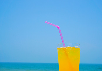 Orange juice drinking on the beach.  ビーチで飲むオレンジジュース