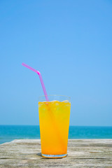 Orange juice drinking on the beach.  ビーチで飲むオレンジジュース
