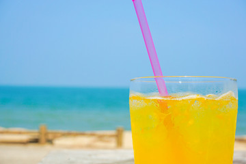 Orange juice drinking on the beach.  ビーチで飲むオレンジジュース