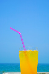 Orange juice drinking on the beach.  ビーチで飲むオレンジジュース