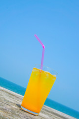 Orange juice drinking on the beach.  ビーチで飲むオレンジジュース