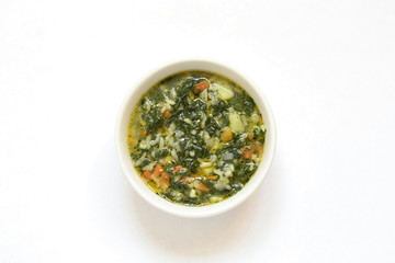 Nettle soup served with egg and sour cream, top view