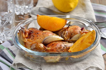 Baked in the oven chicken with orange, garlic and onion