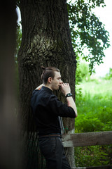 Young handsome stylish man smoking cigar