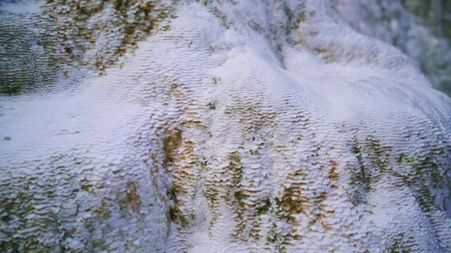 Hot spring. Hot water is floating over white termal limestone cliffs. Bagni San Filippo, Italy