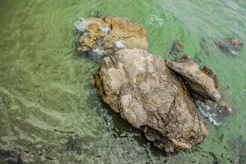 resort blue and green sea water surface waterfront district nature landscape empty environment concept with stones and small waves