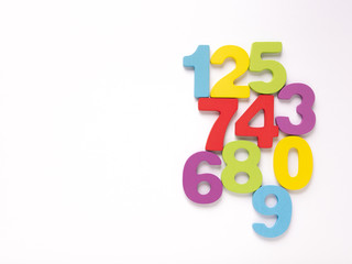 Colorful wooden numbers on white background, Number set zero to nine, top view and copy space