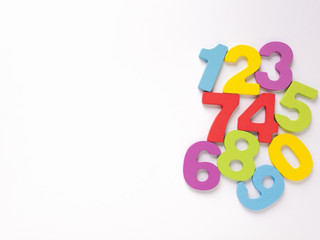 Colorful wooden numbers on white background, Number set zero to nine, top view and copy space