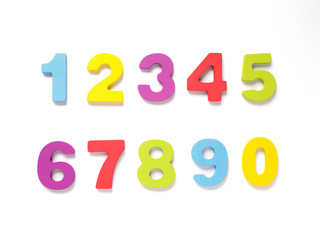 Colorful wooden numbers on white background, Number set zero to nine, top view