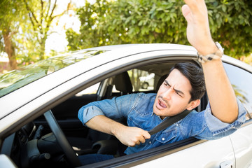 Annoyed driver arguing and gesturing on road