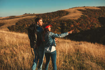 Young hikers couple with backpack on mountain enjoy on a sunny day