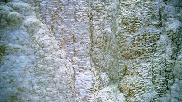 Hot spring. Hot water is floating over white termal limestone cliffs. Bagni San Filippo, Italy