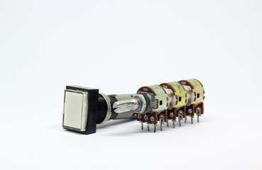 Six gangs potentiometer or variable resistor and push botton switch on white background.