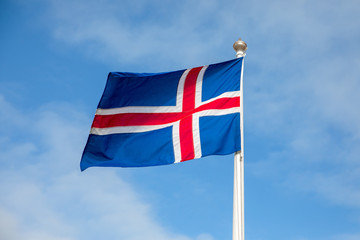 Flag of Iceland waving on the wind with blue sky background