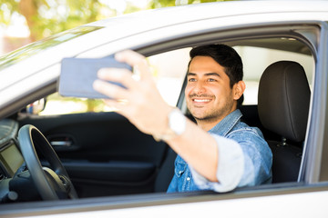 Man taking selfie in his new car