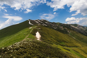 Chkhunderi pass in the summertime in Svaneti mountains with cloudy sky on background