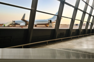 Wooden desk of free space and airport background with big window 