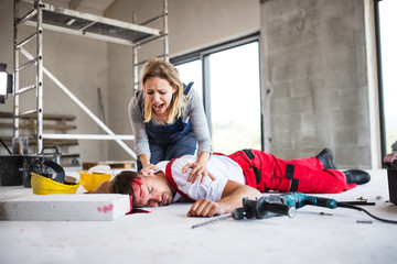 A woman found man worker lying unconscious on the floor at the construction site.