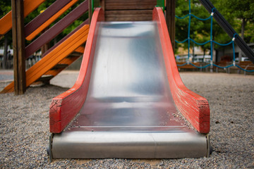 Metal slide with red sides on a kid park
