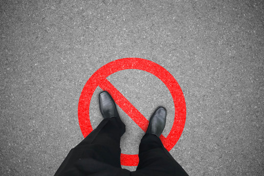 Businessman in black shoes standing on the wrong place that prohibited and not allowed