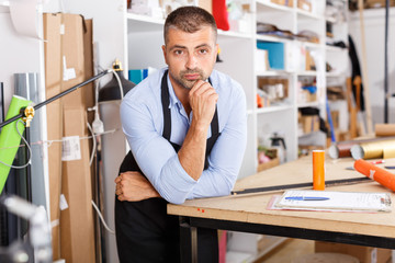 man designer and print operator with paper print at the print manufacturing