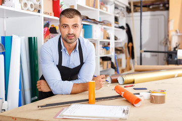 man designer and print operator with paper print at the print manufacturing