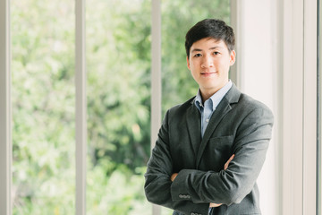 Fototapeta premium Young confident Asian businessman smiling