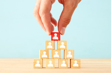 image of wooden blocks with people icons over table ,building a strong team, human resources and...