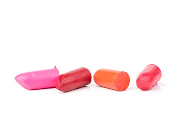 Lipstick slices collection. Close up of four slices lipstick on white background