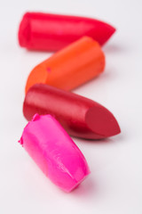 Lipstick slices collection. Close up of four slices lipstick on white background