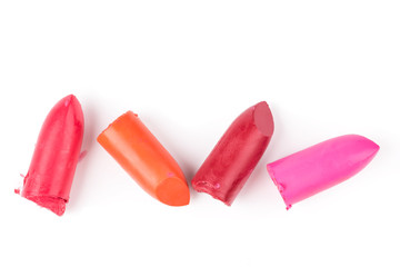 Top view of lipstick slices on white background