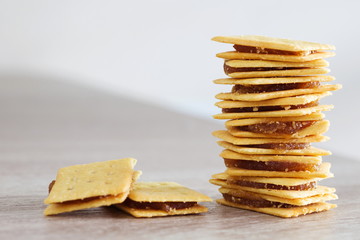 Biscuit with pineapple jam on the wooden table.