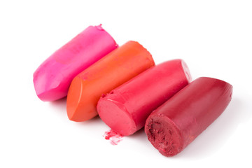 Lipstick slices collection. Close up of four slices lipstick on white background