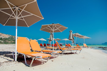 View at parasol and sunbeds at sea lagoon of Balos, Greece in summertime season, July