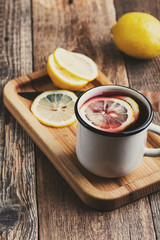 Cozy hot winter drink with lemon slices