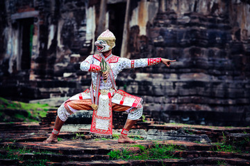 Hanuman-TossakanThai high classical dance in mask. Thai traditional dancing in a nice green, white  color shiny outfit background by historical temple in Lopburi province.