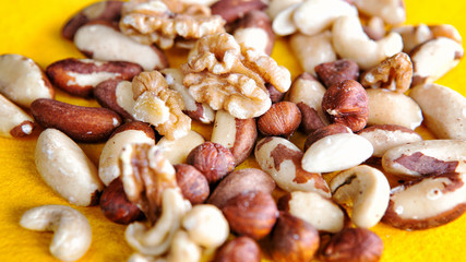 group of mixed nuts on yellow plate