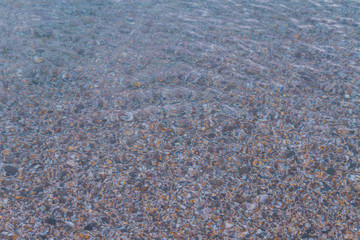 Sea stones in the summer sea before sunset