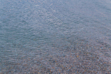 Sea stones in the summer sea before sunset