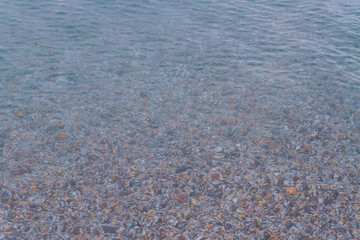 Sea stones in the summer sea before sunset